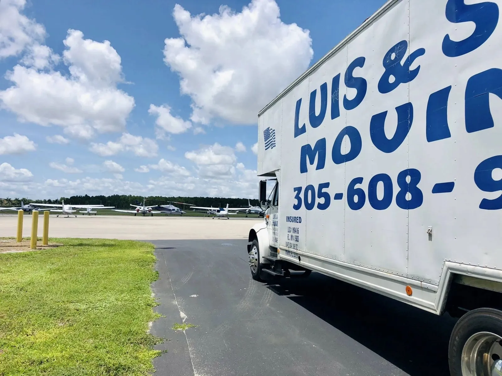 Luis & Son Moving box truck parked at a Miami airfield